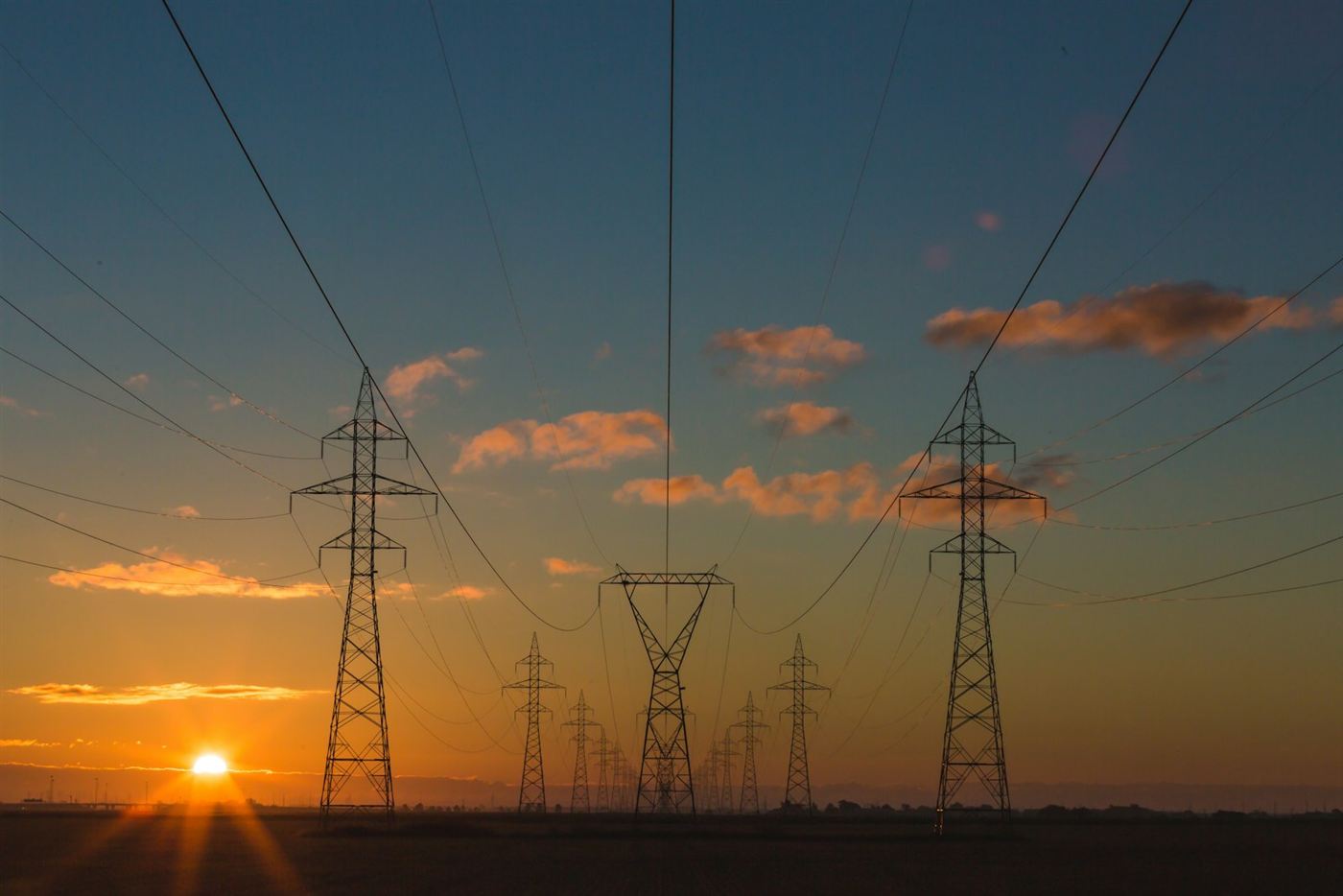 High-voltage transmission towers at dusk